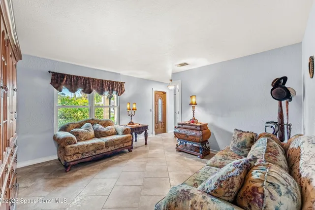 a kitchen with stainless steel appliances granite countertop a refrigerator a stove and a sink