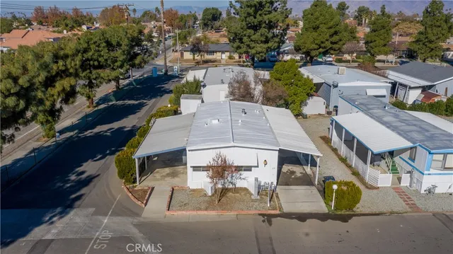 an aerial view of a house with garden space and street view