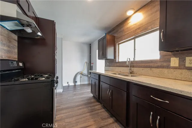 a kitchen with a sink stove and cabinets