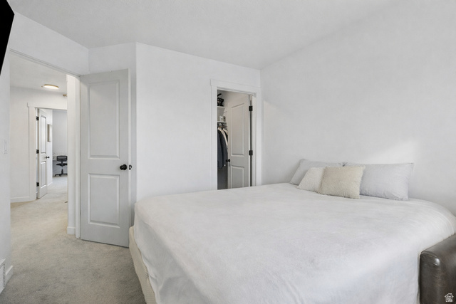 3473 Hardman Way Lehi, UT 84048 - Photo 16 of 22 Bedroom featuring a spacious closet and light carpet