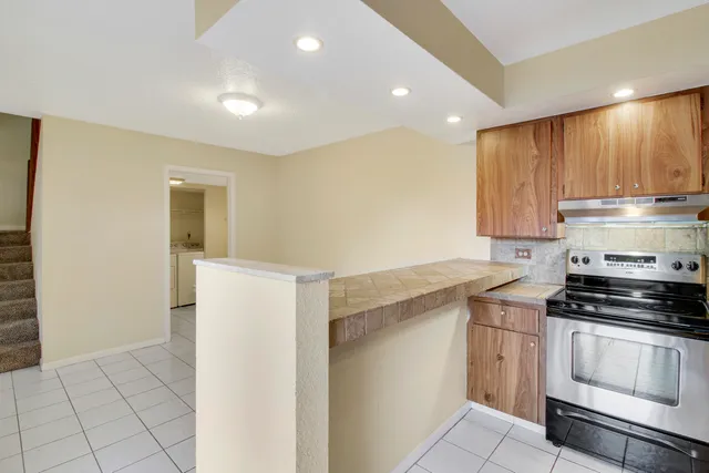 a bathroom with a granite countertop sink toilet and a mirror