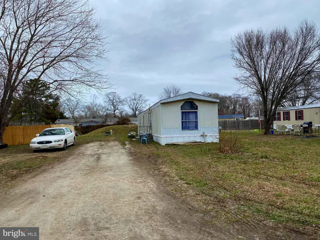 a view of a house with a truck parked in front of a house