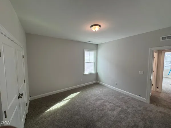 a spacious bathroom with a double vanity sink a mirror and a