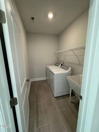 a kitchen with stainless steel appliances kitchen island wooden cabinets and a refrigerator