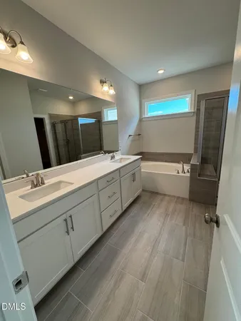 a bathroom with a bathtub and shower