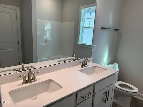 a bathroom with a shower and a sink
