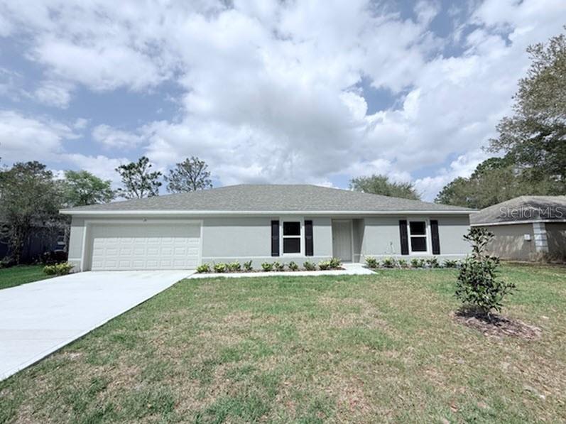 39 Slipper Trail Palm Coast, FL 32164 - Photo 1 of 13 front view of house with a yard
