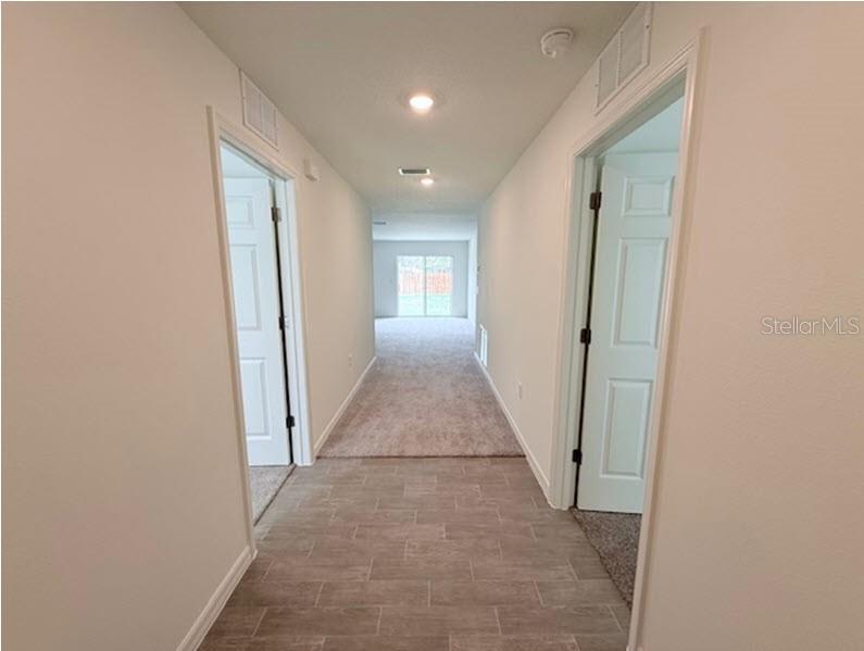 39 Slipper Trail Palm Coast, FL 32164 - Photo 2 of 13 a view of a hallway with wooden floor and closet