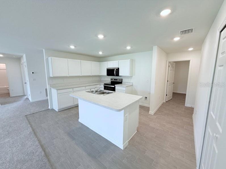 39 Slipper Trail Palm Coast, FL 32164 - Photo 4 of 13 a view of kitchen with stainless steel appliances granite countertop a stove and a refrigerator