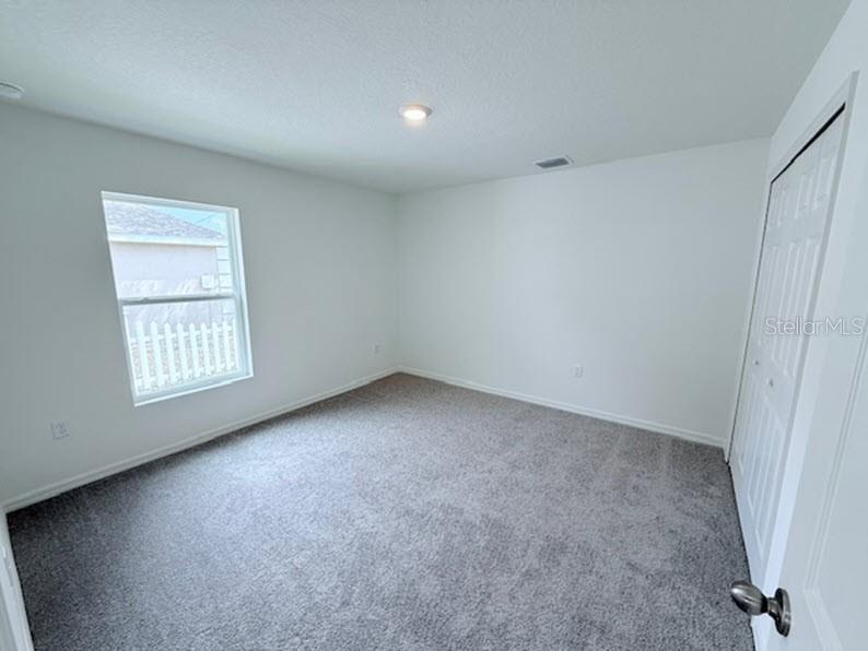 39 Slipper Trail Palm Coast, FL 32164 - Photo 8 of 13 an empty room with windows