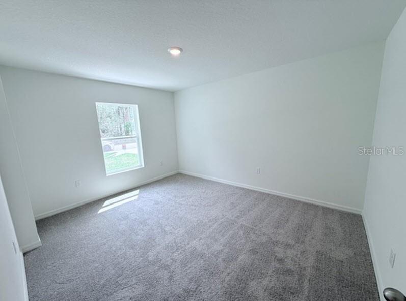 39 Slipper Trail Palm Coast, FL 32164 - Photo 9 of 13 an empty room with windows