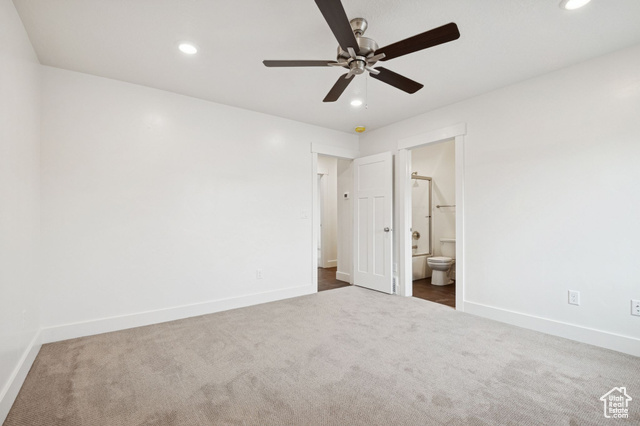 1615 North Angel Street, Unit F Layton, UT 84041 - Photo 15 of 45 Unfurnished bedroom featuring dark carpet, ceiling fan, recessed lighting, and ensuite bath