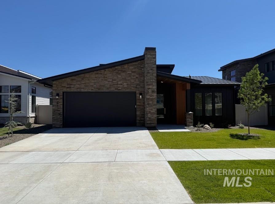 683 West Wrangler Street Meridian, ID 83646 - Photo 1 of 23 Contemporary single-story residence showcasing a prominent stone veneer facade and black horizontal siding
