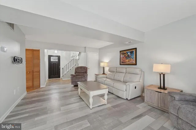 a living room with furniture a lamp and a potted plant