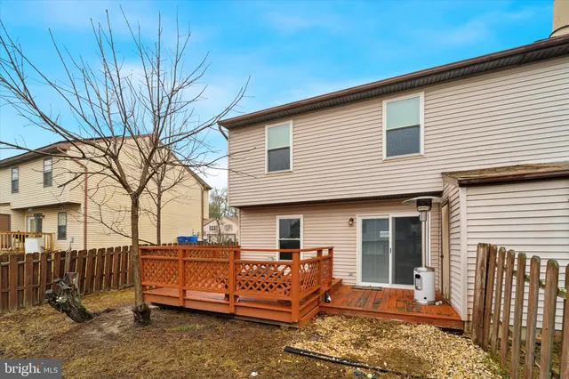 a front view of a house with a large tree