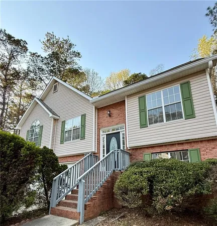 a front view of a house with a garden