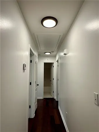 a view of a hallway with wooden floor