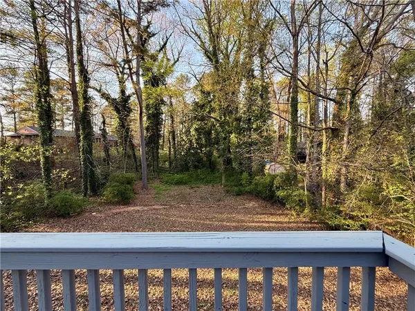 a view of a wooden fence and a trees