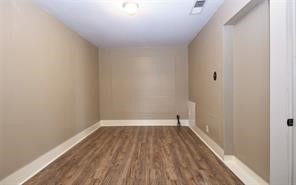 2527 Oakcliff Street Houston, TX 77023 - Photo 7 of 15 a view of a room with wooden floor and a window
