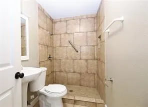 a bathroom with a toilet and a shower