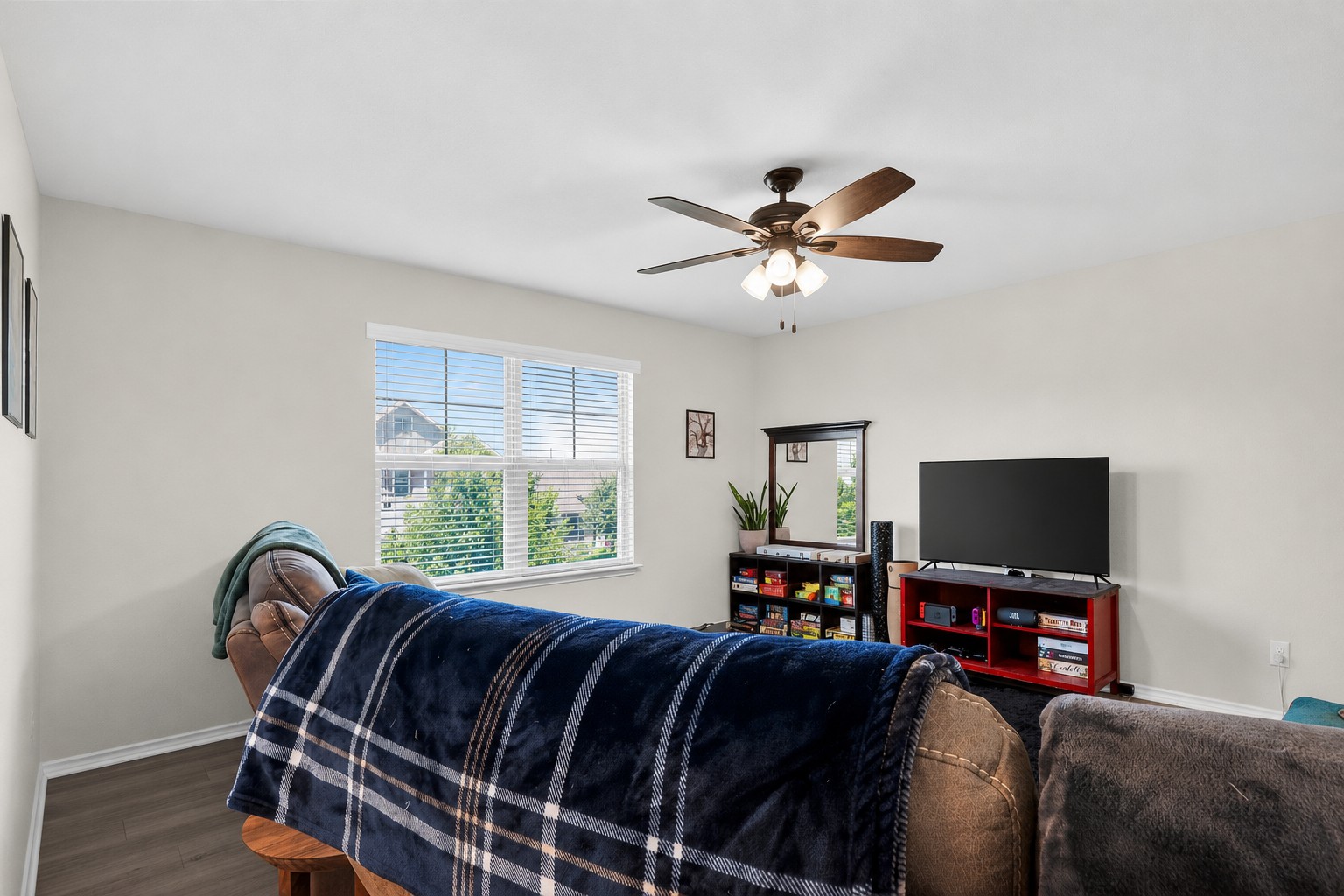 521 Staton Street Georgetown, TX 78626 - Photo 13 of 39 a bedroom with a bed and a flat screen tv