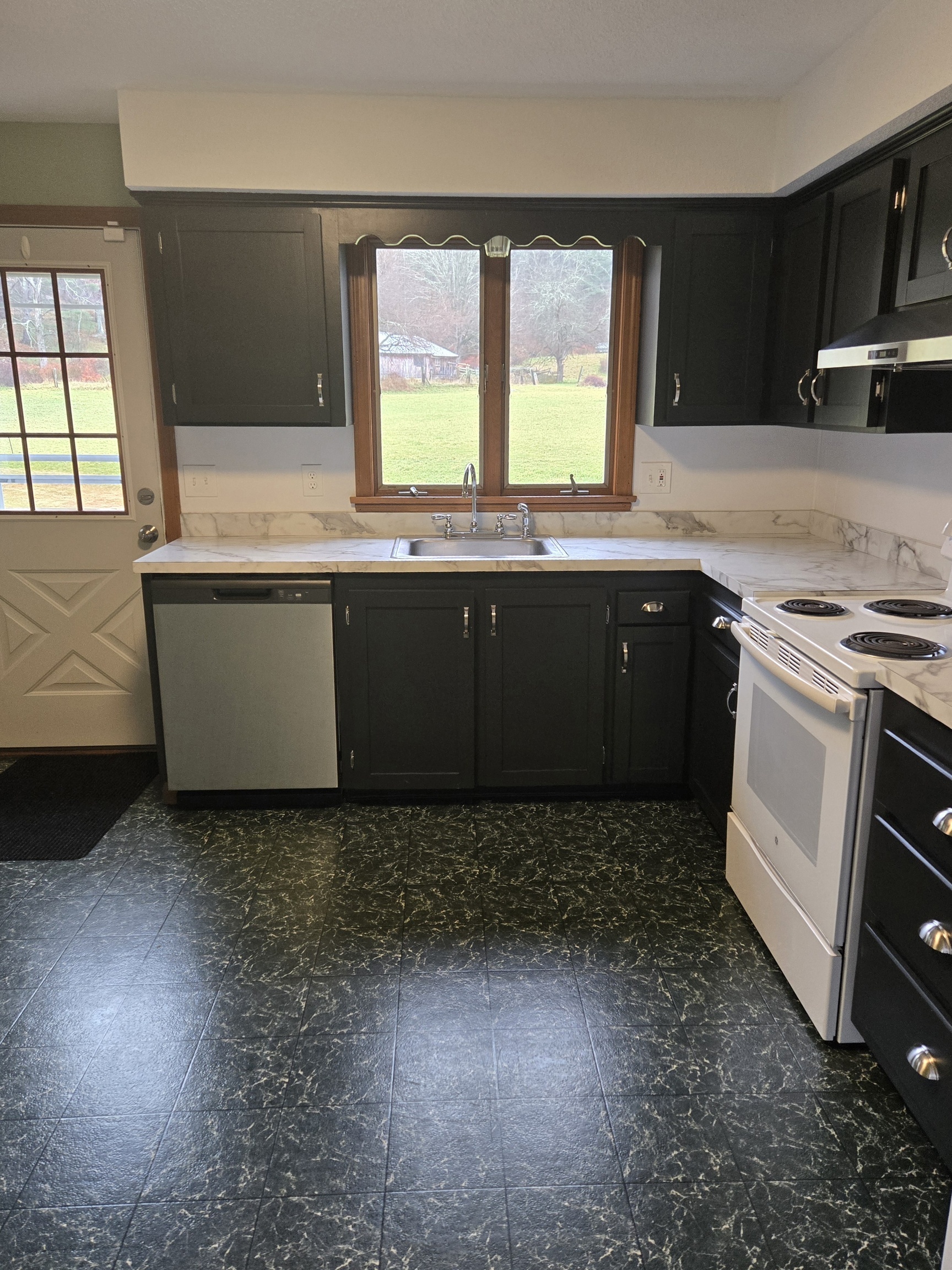 48 River Road Mansfield, CT 06250 - Photo 11 of 27 a kitchen with granite countertop a stove a sink and a microwave