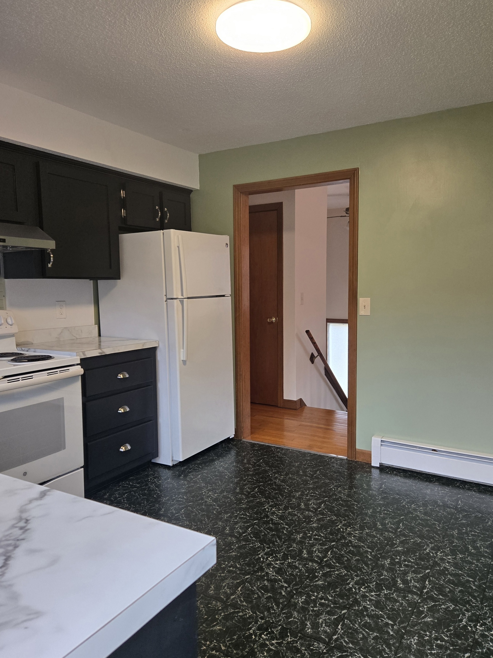 48 River Road Mansfield, CT 06250 - Photo 13 of 27 a kitchen with a refrigerator and a stove