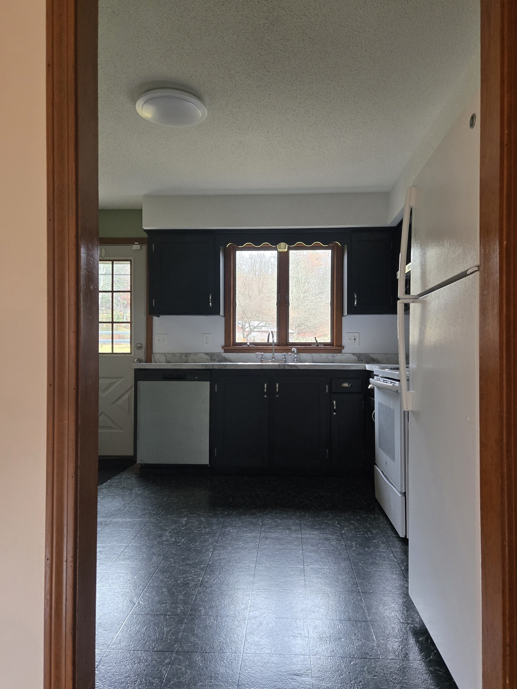 48 River Road Mansfield, CT 06250 - Photo 8 of 27 a kitchen with a refrigerator and a sink