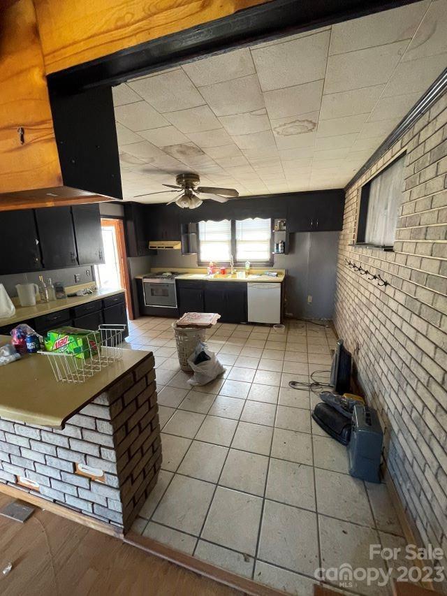 3240 Sam Jones Road Patrick, SC 29584 - Photo 28 of 35 a kitchen with stainless steel appliances kitchen island granite countertop a refrigerator and a stove