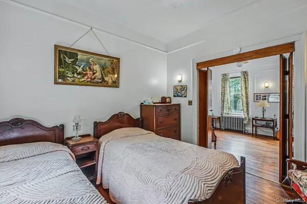 a bedroom with a bed and a large mirror
