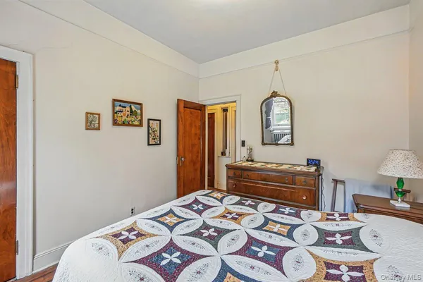 a bedroom with a bed and a dresser in it
