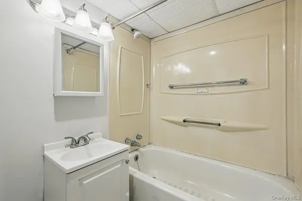 a bathroom with a sink a mirror and a bathtub