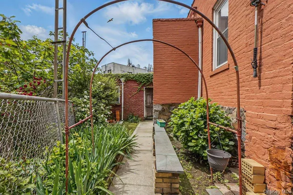 a view of a pathway of flower plants