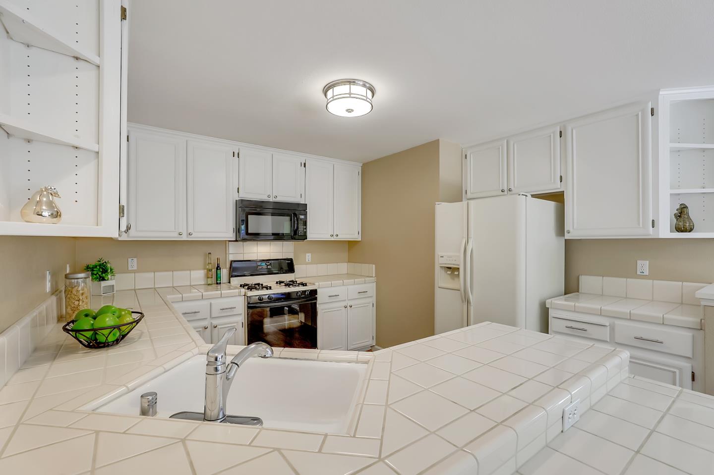 504 Weiner Way San Ramon, CA 94582 - Photo 9 of 41 a kitchen with a refrigerator a stove top oven a sink a dining table and chairs