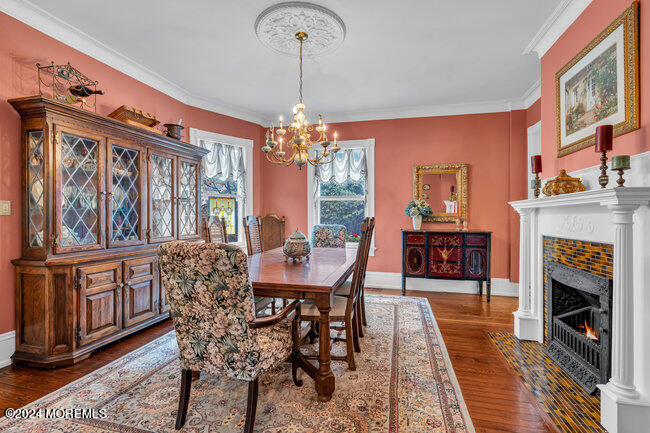 116 Washington Avenue Spring Lake, NJ 07762 - Photo 11 of 26 a dining room with furniture a chandelier and wooden floor