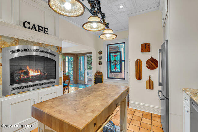 116 Washington Avenue Spring Lake, NJ 07762 - Photo 14 of 26 a view of a kitchen area with furniture and chandelier