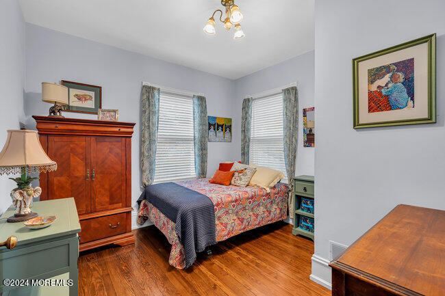 116 Washington Avenue Spring Lake, NJ 07762 - Photo 16 of 26 a bedroom with a bed and wooden floor