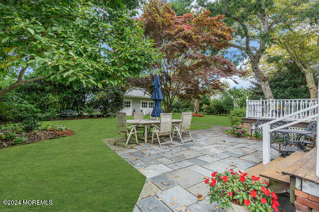 116 Washington Avenue Spring Lake, NJ 07762 - Photo 25 of 26 a view of a table and chairs in the garden
