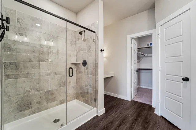 a bathroom with a glass shower door