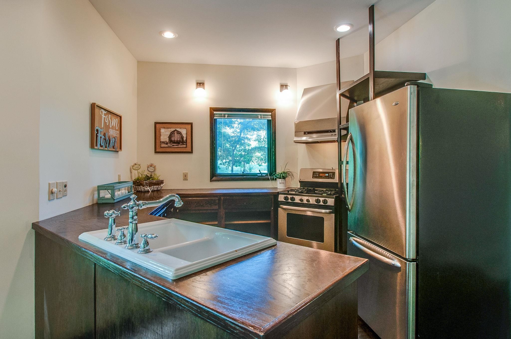 7426 Pinewood Road Franklin, TN 37064 - Photo 11 of 30 a kitchen with stainless steel appliances a refrigerator a sink a stove a dining table and chairs