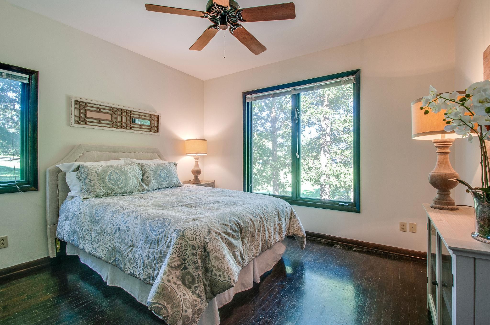 7426 Pinewood Road Franklin, TN 37064 - Photo 13 of 30 a bedroom with a bed and wooden floor