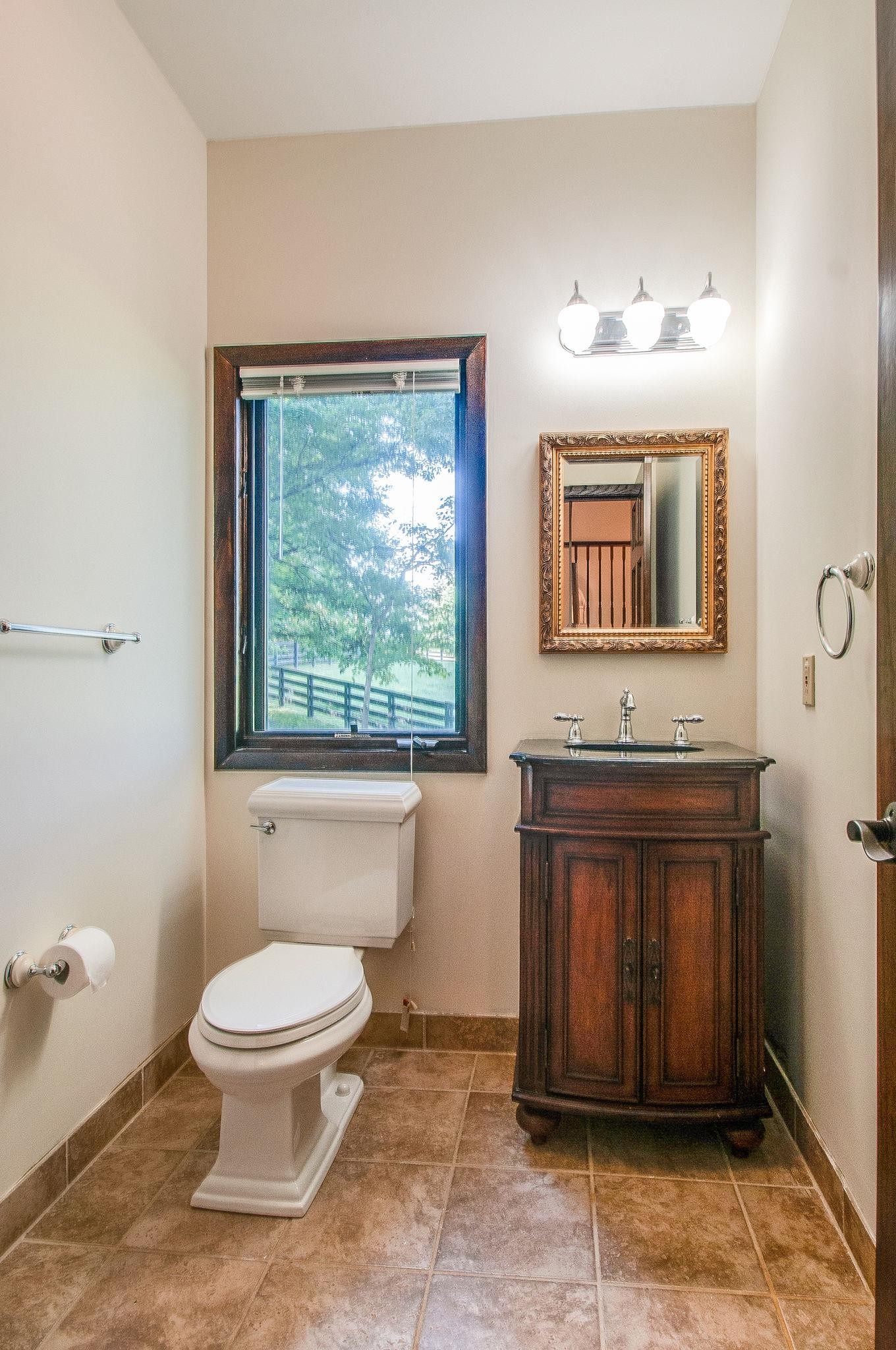7426 Pinewood Road Franklin, TN 37064 - Photo 14 of 30 a spacious bathroom with a toilet sink and mirror
