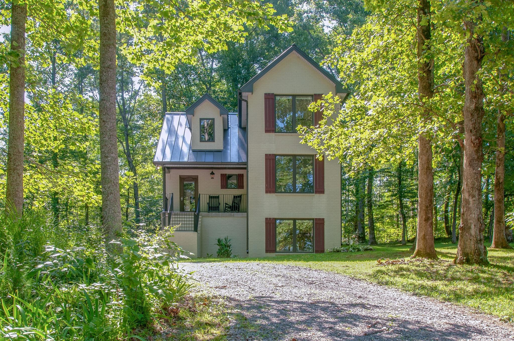 7426 Pinewood Road Franklin, TN 37064 - Photo 2 of 30 a front view of a house with a garden and trees
