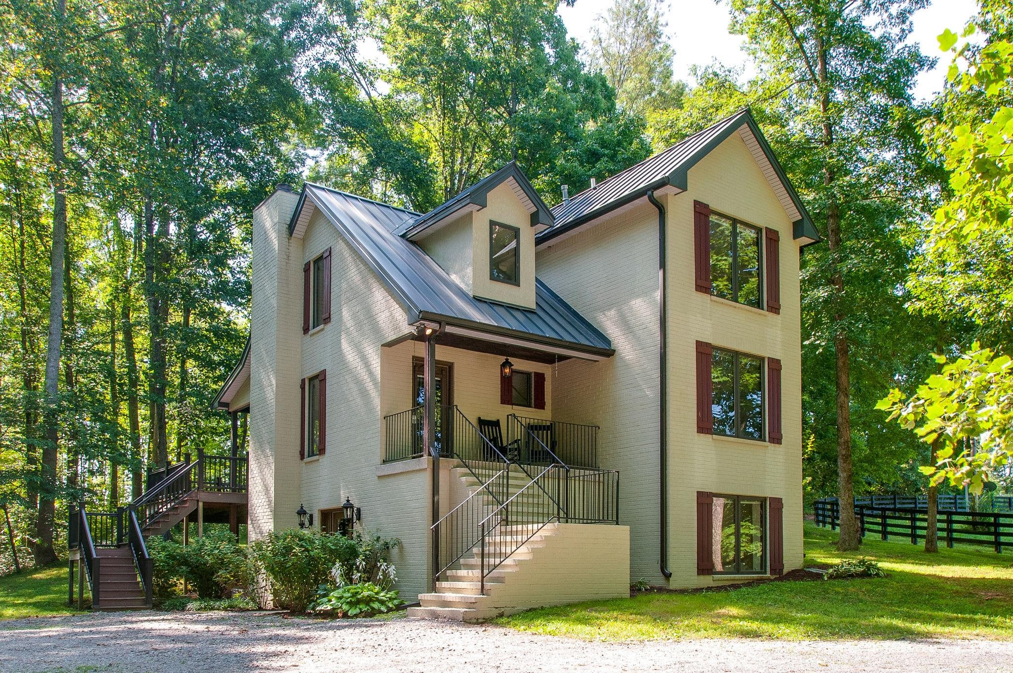 7426 Pinewood Road Franklin, TN 37064 - Photo 6 of 30 a front view of a house with a yard table and chairs