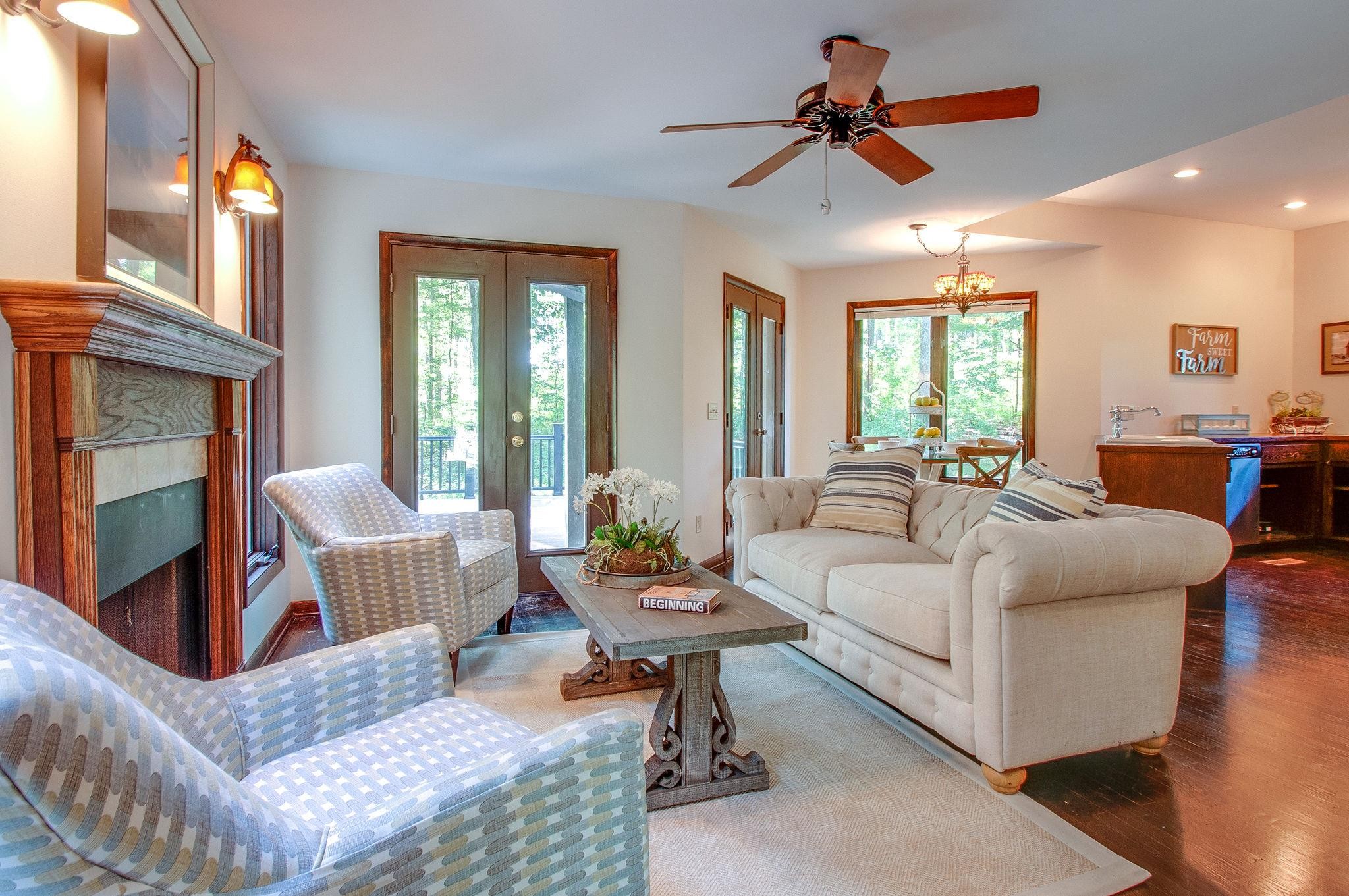 7426 Pinewood Road Franklin, TN 37064 - Photo 8 of 30 a living room with furniture a fireplace and a chandelier
