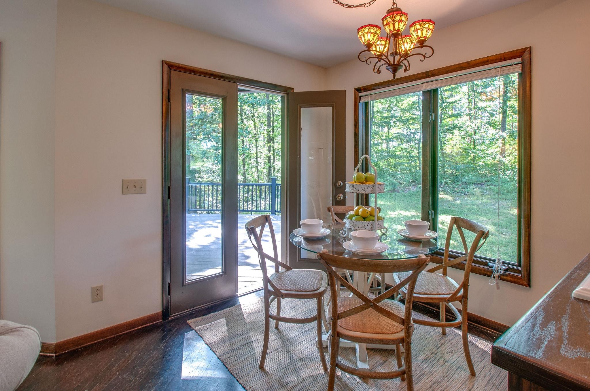 7426 Pinewood Road Franklin, TN 37064 - Photo 9 of 30 a view of a dining room with furniture a chandelier and wooden floor
