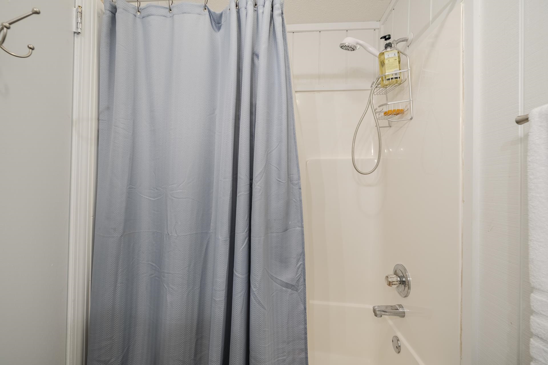 80 Contreau Road Counce, TN 38326 - Photo 15 of 28 Bathtub and shower combination featuring a flexible shower head, chrome fixtures, and white paneled walls