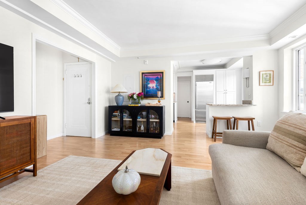 a living room with furniture and a wooden floor