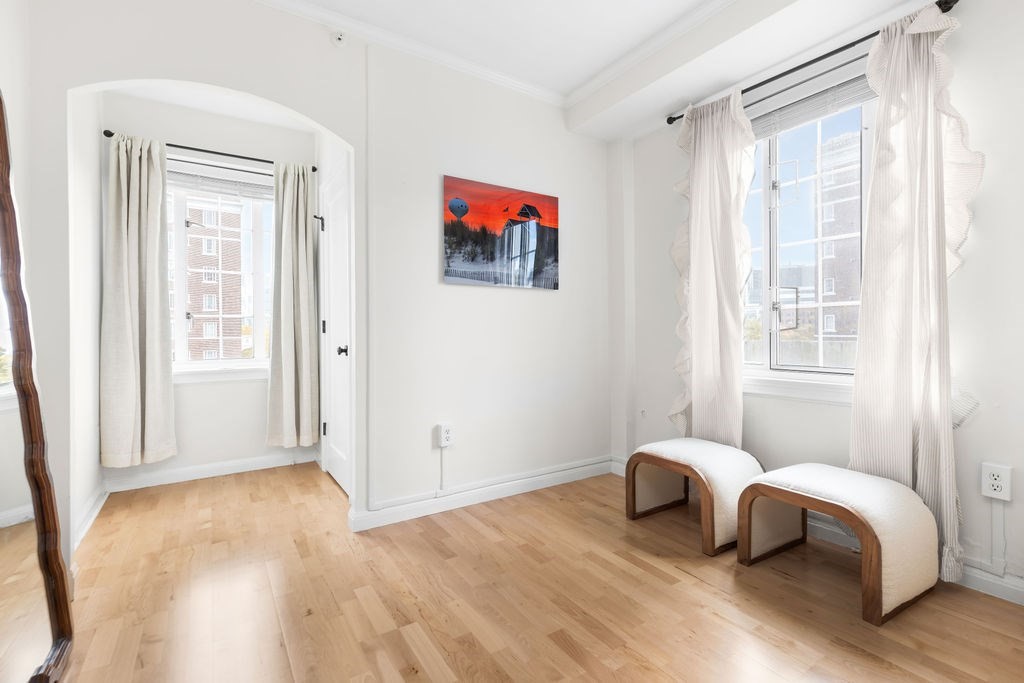 20 Chapel Street, Unit B712 Brookline, MA 02446 - Photo 11 of 25 a bedroom with a bed and wooden floor