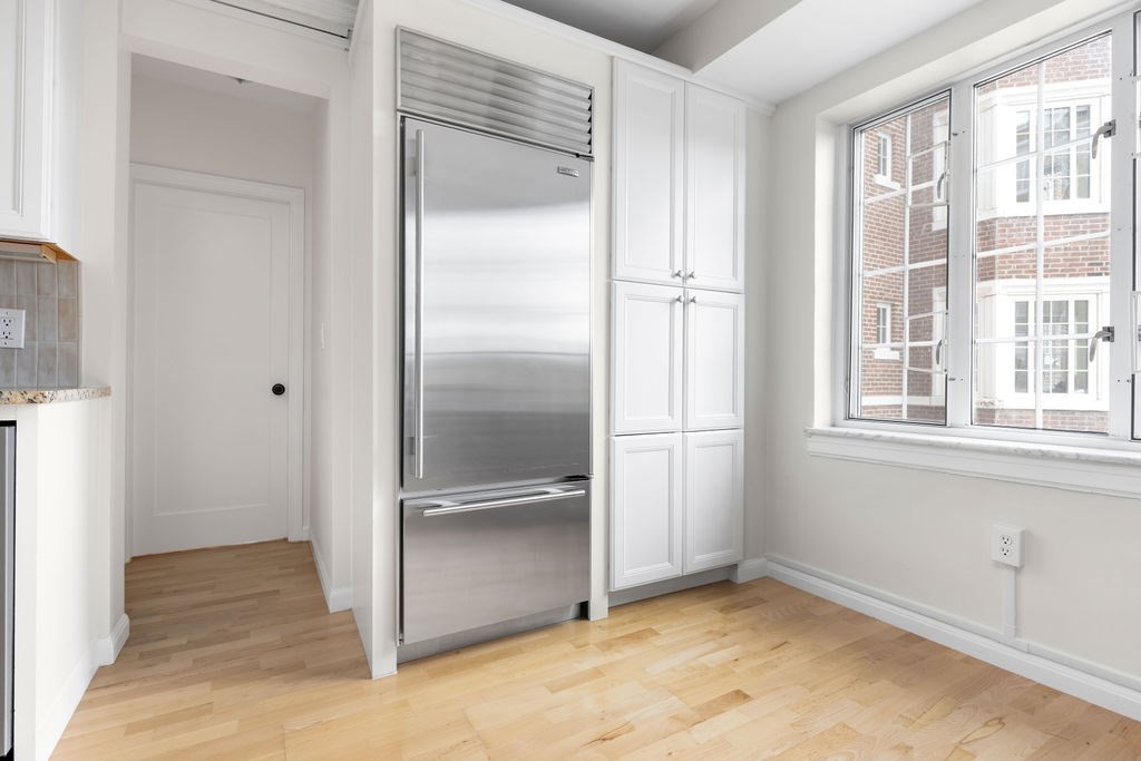 20 Chapel Street, Unit B712 Brookline, MA 02446 - Photo 5 of 25 a view of a refrigerator in a kitchen